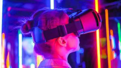 Back view: woman using virtual reality headset at interactive VR exhibition Foto stock