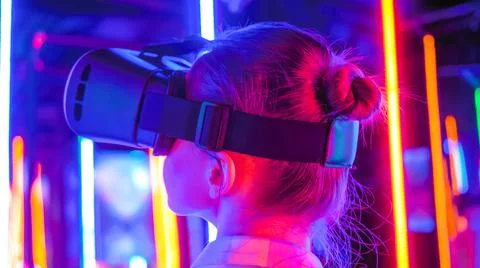Back view: woman using virtual reality headset at interactive VR exhibition Foto stock