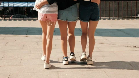 Back view of women's sexy long legs going slowly in the street 库存影片 141786422