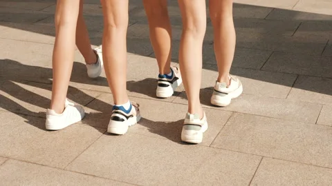 Back view of women's sexy long legs going slowly in the street Видео 141786616