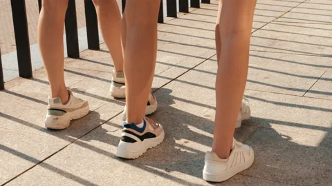 Back view of women's sexy long legs going slowly in the street 動画素材 141786899