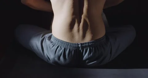 Back view of yogi man preparing for workout meditation zen practice indoors on Stock Footage 150347272