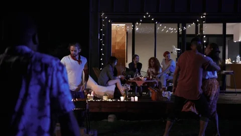 Back view of young Afro-American man joining the party, greeting with his Video stock 91921259
