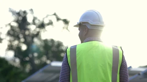 Back view Young asian electrical engineer standing in front of Solar cell panels Stock Footage 158902823