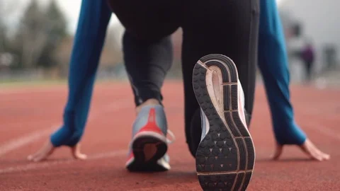 Back view of a young athlete getting ready for the race on a running track. Stock Footage 121199575
