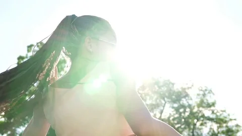 Back view of young beautiful girl with dreads dancing in a park. Beautiful woman Stock Footage