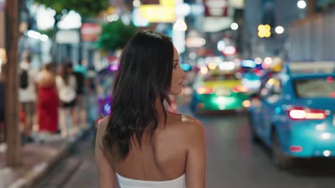 Back View of a Young Beautiful Tourist Woman Exploring the Night Cityscape. Stock Footage 281185359