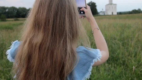Back view of Young Beautifull Blond Woman travelling to Church of the Stock Footage 92461089