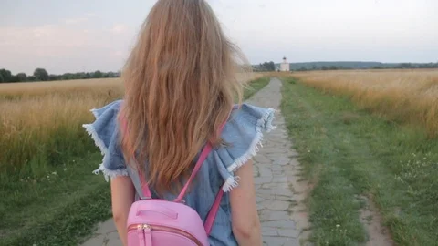 Back view of Young Beautifull Blond Woman travelling to Church of the Stock Footage 92461396