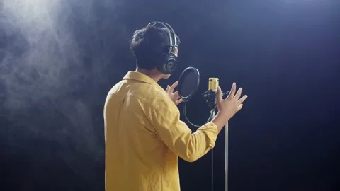 Back View Of A Young Boy With Headphone Singing Into A Condenser Microphone Stock Footage 204008996
