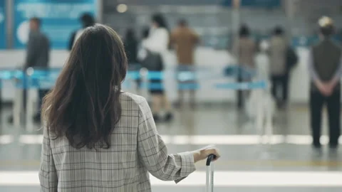 Back view of young businesslady in a middle of airport terminal. Woman waiting Stock Footage 157220706