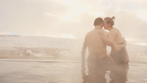 Back view. Young couple in hot spring. Couple relaxing in spa resort Stock Footage 106276140