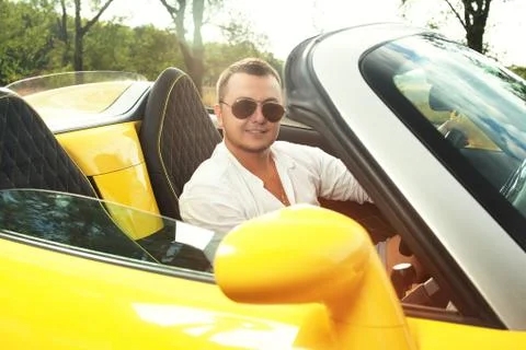 Back view of young driver in sunglasses of convertible ride Stock Photos