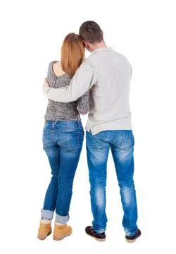Back view of young embracing couple (man and woman) hug and look Foto stock