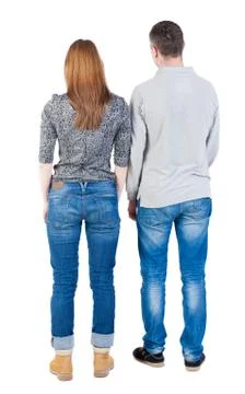 Back view of young embracing couple (man and woman) hug and look Stock Photos