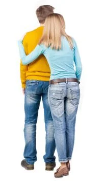 Back view of young embracing couple Stock Photos