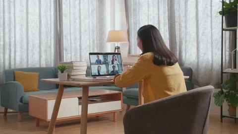 Back View Of A Young Female Waving Hand For Greeting While Studying On Zoom By Stock Footage 215857150