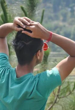 Back view of a young guy wearing sunglass and posing in outdoor  Stock Photos