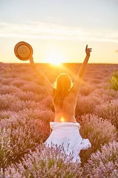 Back view of young happy half naked woman with outstretched arms holding straw Stock Photos