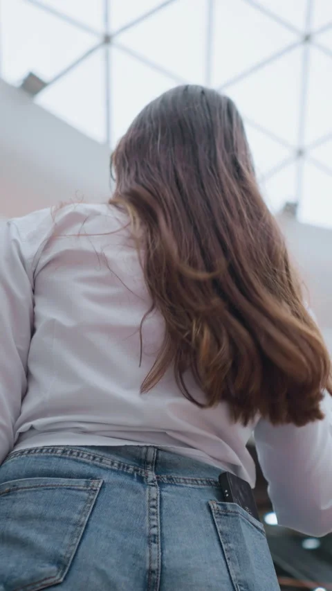 Back View of Young Lady on Moving Escalator in Modern Mall Stock Footage 318839344