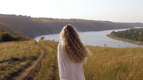 Back view of a young long-haired blonde model girl with golden hair Stock Footage 236559365