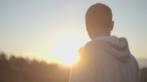 Back view of young man looking at sun in nature mountain outdoor 스톡 동영상 64543610