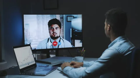 Back view of young man making video call with head doctor about coronavirus Stock Footage 143450896