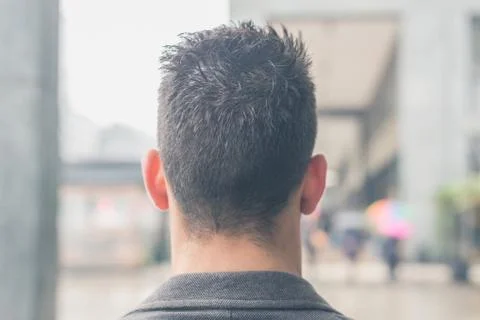 Back view of a young man posing in the city streets Stock Photos
