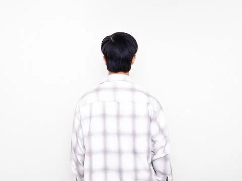 Back view of a young man standing against a clean white background Stock Photos