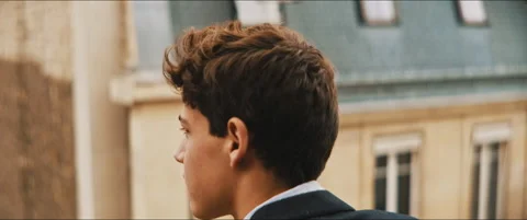 Back view of a young man staring outside in a windy day Stock Footage 203586835