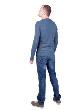Back view of young man in t-shirt and jeans  looking Foto stock