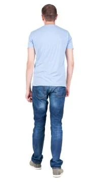 Back view of young man in t-shirt and jeans  looking. guy standi Stock-Fotos