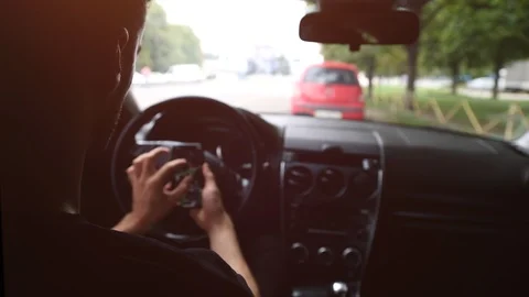 Back View of Young Man Using Phone Inside Car on Driver Seat. Stock Footage 109604752