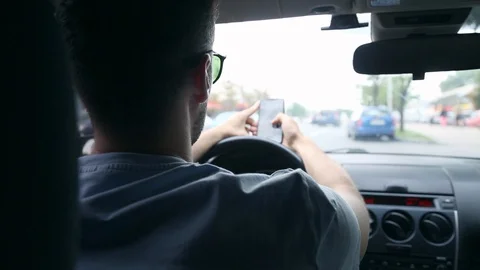 Back View of Young Man Using Phone Inside Car on Driver Seat. Stock Footage 109604926