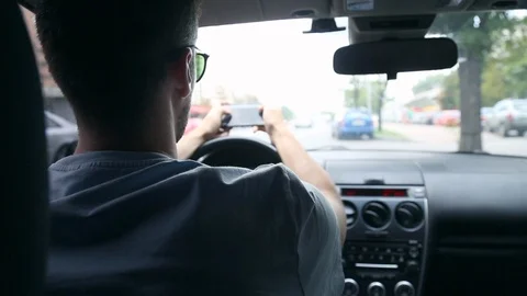 Back View of Young Man Using Phone Inside Car on Driver Seat. Stock Footage 109605109