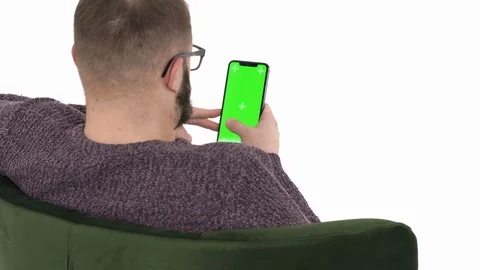 Back view of a young man using smartphone, browsing online reading funny social Stock Footage 121196765