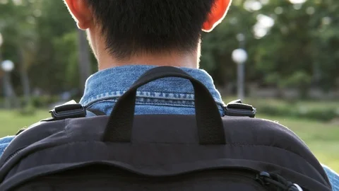 Back view of young man walking at mornin... | Stock Video | Pond5