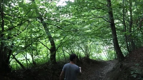 Back view of a young man walking on a su... | Stock Video | Pond5