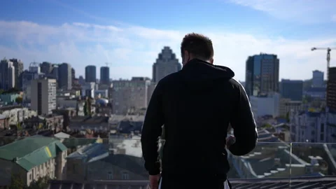 Back view young man walking to glass fen... | Stock Video | Pond5