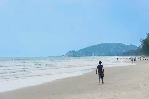 Back view of young man walking on beach. Portrait happy guy while walking a.. Stock Photos