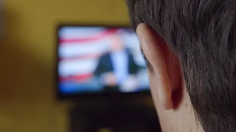 BACK VIEW: A young man watch TV at home Stock Footage 60742759