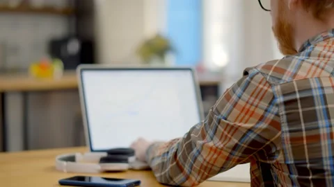 Back view of young man working from home... | Stock Video | Pond5