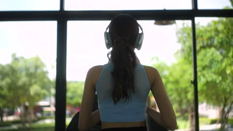Back view of young slim asian woman running on treadmill at health club, female  Stock-Footage 282419831