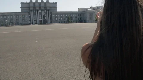 Back view of young white caucasian woman with long dark hair standing on Kuibysh Stock Footage 94855706