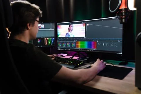 Back view of a young white man videographer working Stock Photos
