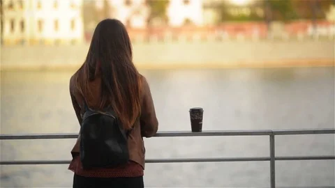 Back View of Young Woman Drinking Cup of Takeaway Coffee from Disposable Cup Stock Footage 69784524
