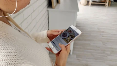 Back view. Young woman looking at her smartphone. Caucasian 動画素材 125928811