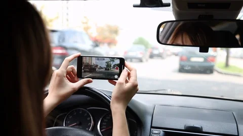 Back View of Young Woman Using Phone Inside Car on Driver Seat. Making Video. Stock Footage 109605064