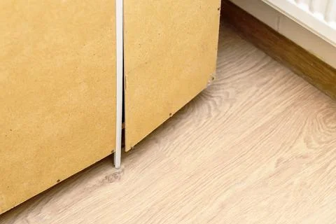 The back wall of the cabinet is broken from a large number of things Stock Photos