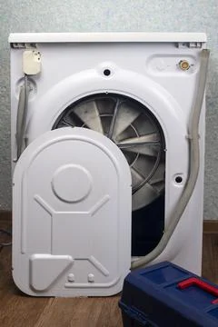 The back of the washing machine is removed, there is a tool box Stock Photos